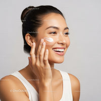 Young Woman Applying Moisturizer to Face for Glowing Skin
