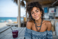 Young Woman Relaxing at Beachside Café with Fruit Drink