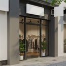 Modern Boutique Entrance with Glass Doors and Displayed Apparel