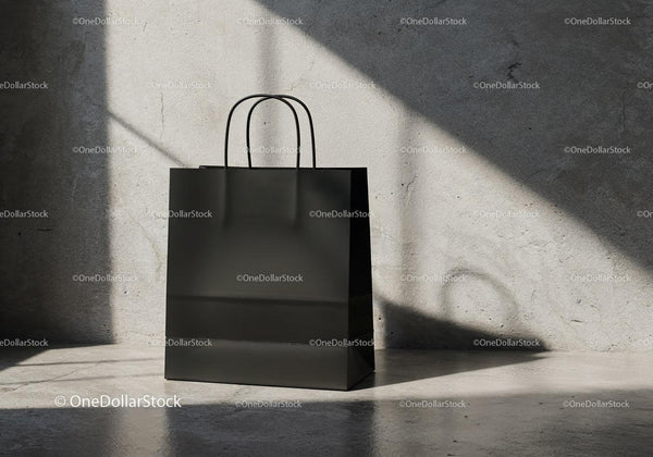 Minimalist Black Shopping Bag on Textured Concrete Floor JPG Mockup Image