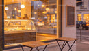 Cozy urban cafe window with warm glowing lights