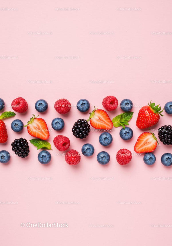 Fresh Mixed Berries with Mint Leaves on Pink Background