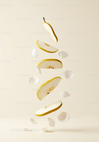 Floating sliced pear with delicate white petals