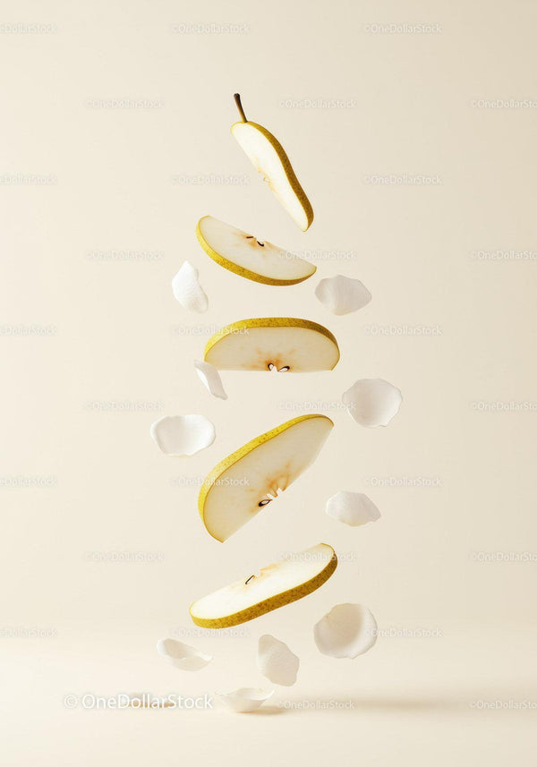 Floating sliced pear with delicate white petals