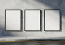 Three Blank Vertical Posters on Urban Concrete Wall
