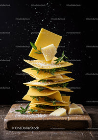 Stack of fresh pasta sheets with parmesan and herbs