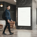 Blurred man walking past blank modern lightbox poster