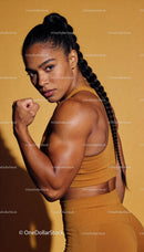 Strong woman flexing muscles in sportswear