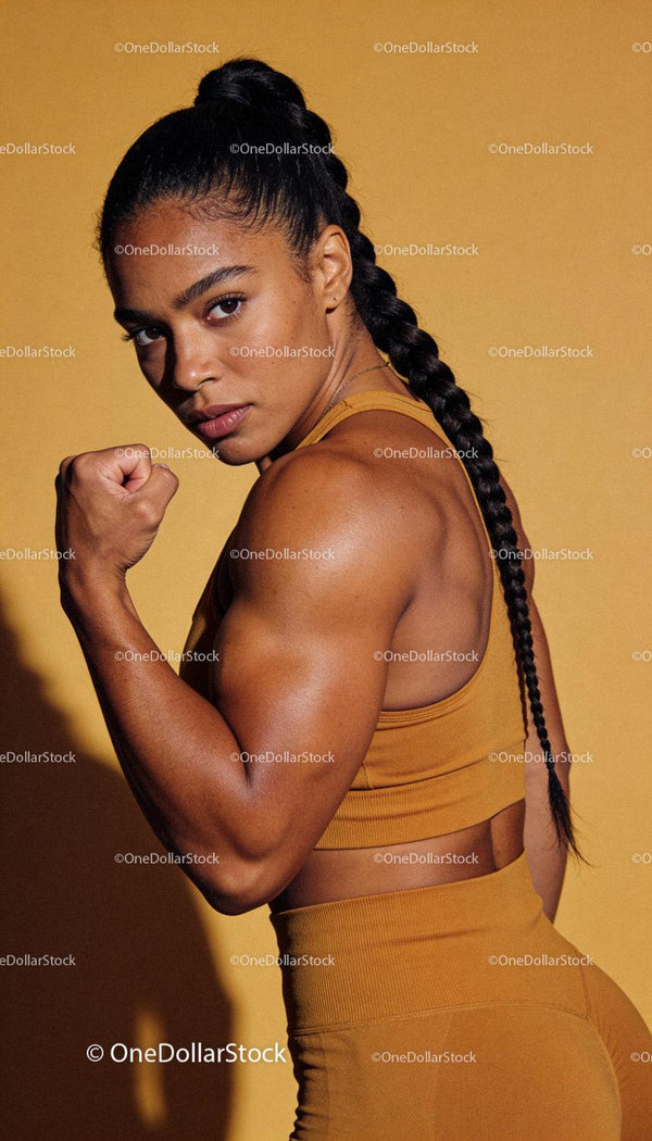 Strong woman flexing muscles in sportswear