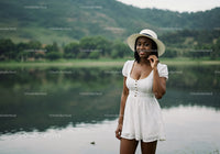 Beautiful Woman in White Dress with Wide-Brim Hat by Lake