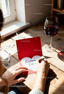 Writing a Love Note on Valentines Day with Red Wine