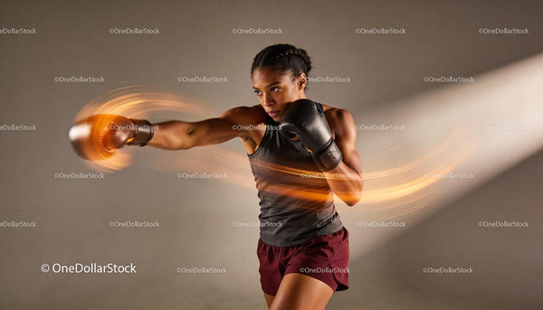 Focused female boxer delivering a powerful punch