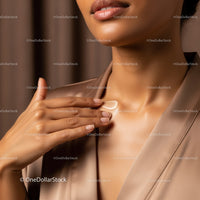 Close-Up of Woman Applying Skincare Product to Sheer Creamy Skin