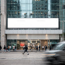 Busy urban street scene with people walking past office building