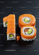 Salmon sushi rolls arranged as number ten on black slate