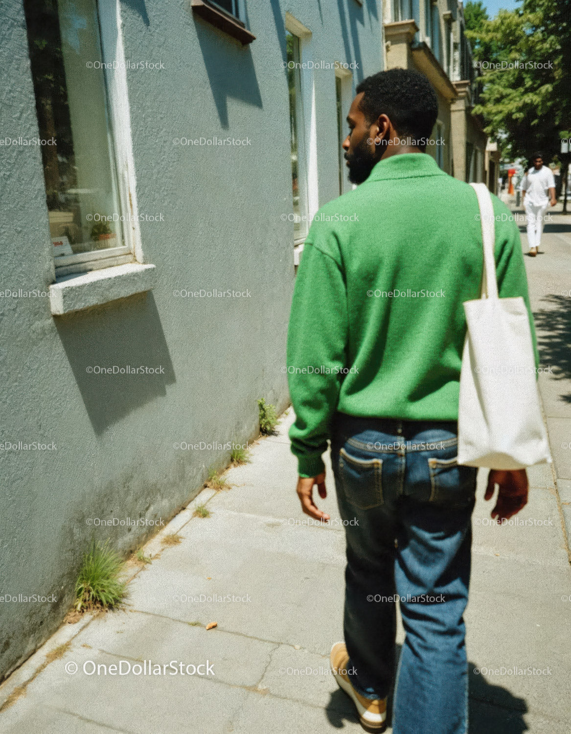 Casual Man Walking in City Street with Green Sweater and Tote Bag