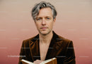 Stylish Adult Man in Brown Velvet Blazer Reading Book Indoors