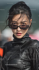 Confident Young Woman in Stylish Black Outfit and Sunglasses