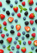 Fresh Mixed Berries and Mint Leaves on Blue Background