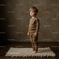 Thoughtful toddler standing barefoot on cozy knit rug