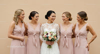 Bride and Bridesmaids Smiling Together at a Joyful Wedding