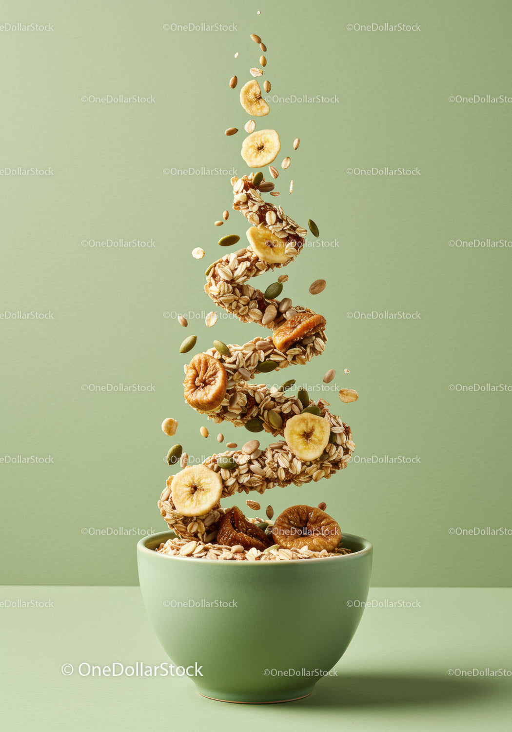 Spiral of healthy granola with dried fruit in green bowl