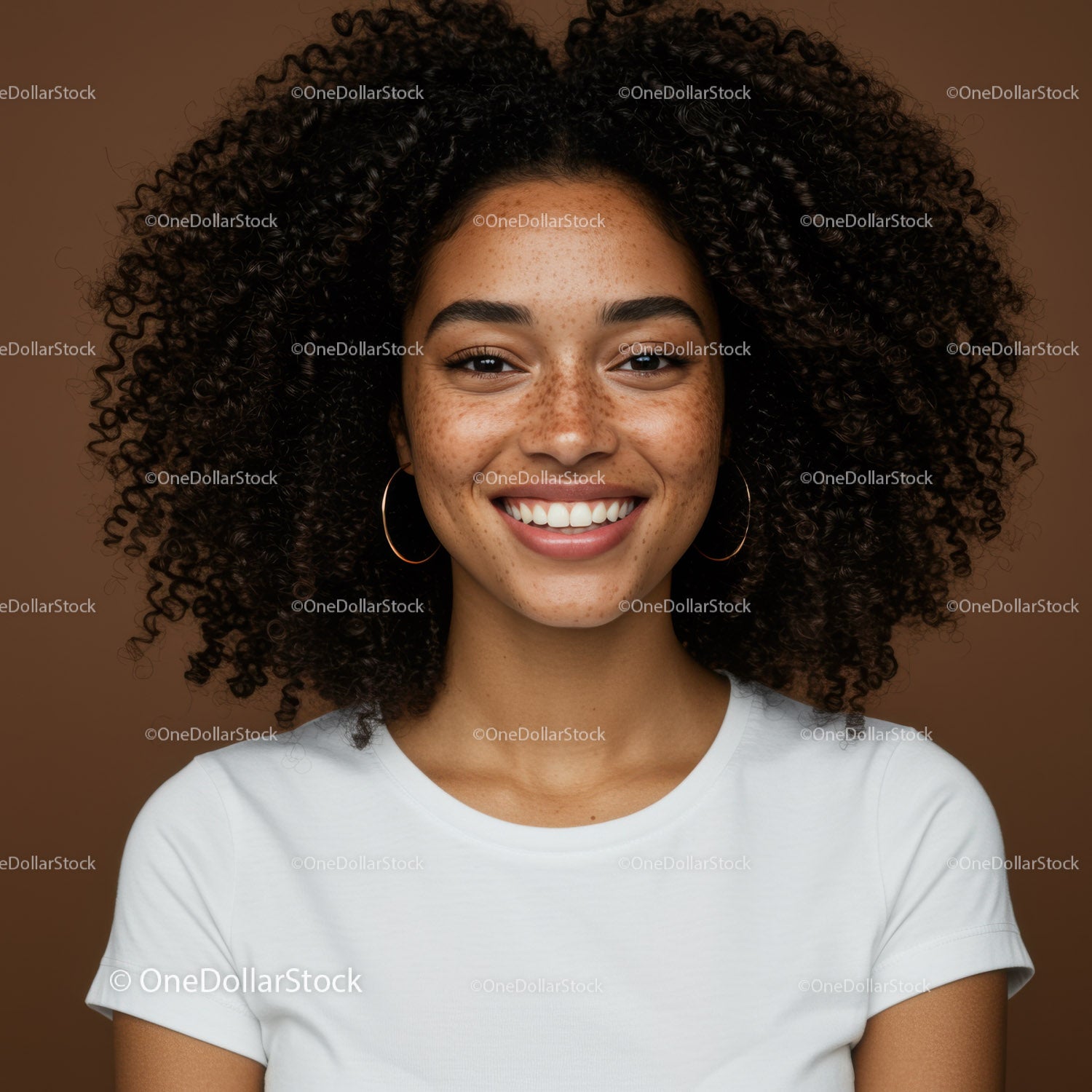 Portrait of a Smiling Woman with Curly Hair and Freckles in Studio