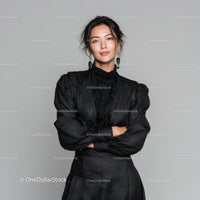 Elegant Young Woman in Black Dress with Jewelry Studio Portrait