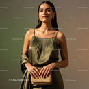 Elegant Woman in Satin Dress with Gold Accessories Holding Handbag