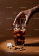 Hand Reaching for Glass of Iced Cold Brew Coffee