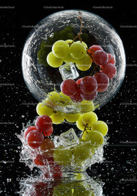 Fresh red and green grapes splashing in water with ice