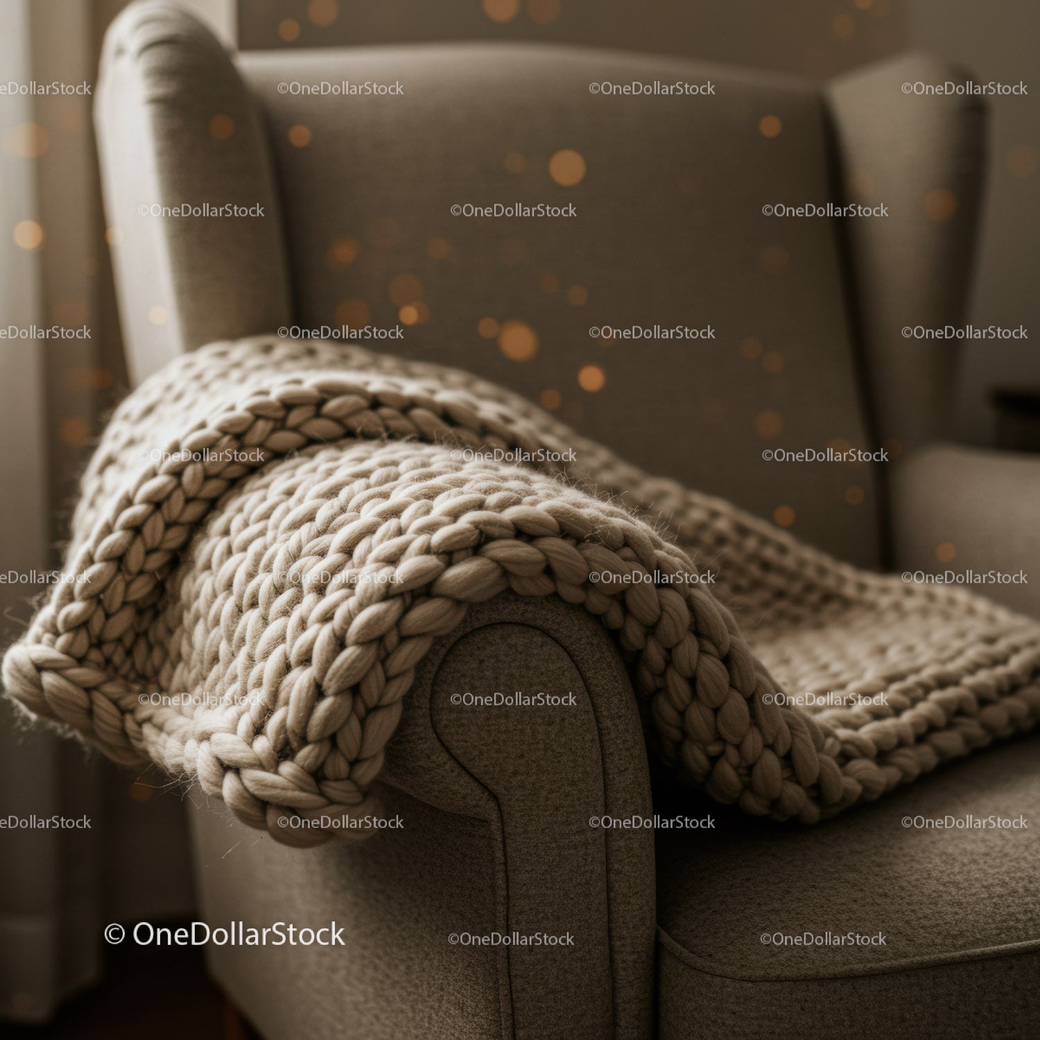 Cozy knitted blanket draped over cushioned armchair