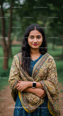 Beautiful woman in traditional saree poses outdoors in a lush park