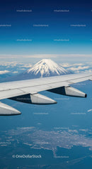 Aerial View of Mount Fuji with Snow-Capped Peak and Aircraft Wing