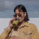 Fashionable Woman Drinking Green Smoothie Outdoors in Summer