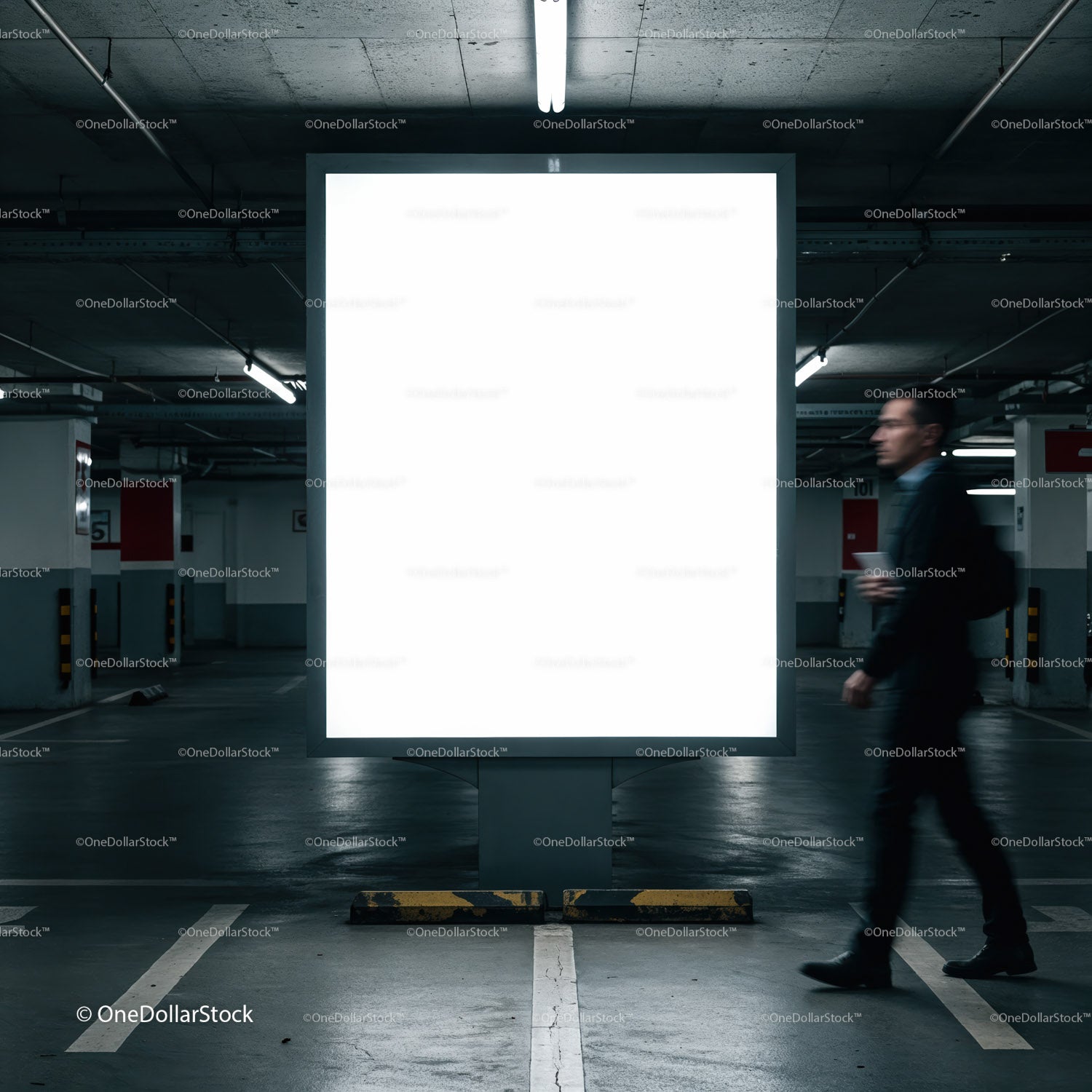 Mężczyzna przechodzi obok oświetlonego, pustego billboardu w garażu parkingowym