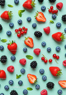 Fresh Mixed Berries with Mint Leaves on Blue Background