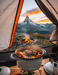 Hearty stew cooking on stove with mountain sunset view