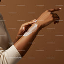 Close-up of Woman Applying Lotion to Arm for Skin Hydration