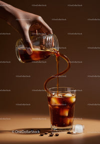 Pouring iced coffee with ice cubes and coffee beans