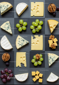 Variety of cheeses with fruits and nuts on slate board