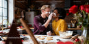 Couple playfully baking heart cookies in cozy kitchen