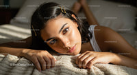 Beautiful Young Woman Lying on Bed in Cozy Bedroom Scene