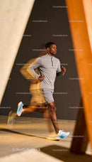 Focused young runner training indoors with motion blur