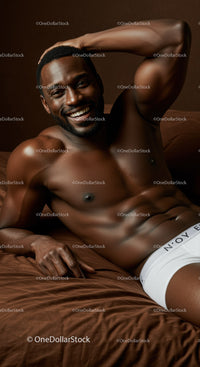Smiling shirtless man relaxing on brown bed linen