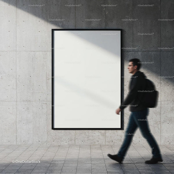 Man walking past empty poster on urban concrete wall JPG Mockup Image