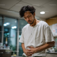 Young Man Experiencing Stomach Pain with Discomfort Expression