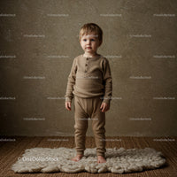 Toddler standing barefoot on cozy wool rug indoors