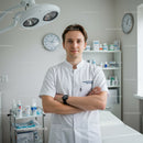 Male healthcare professional standing confidently in modern clinic
