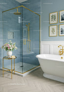 Elegant bathroom with blue tiled shower and freestanding tub